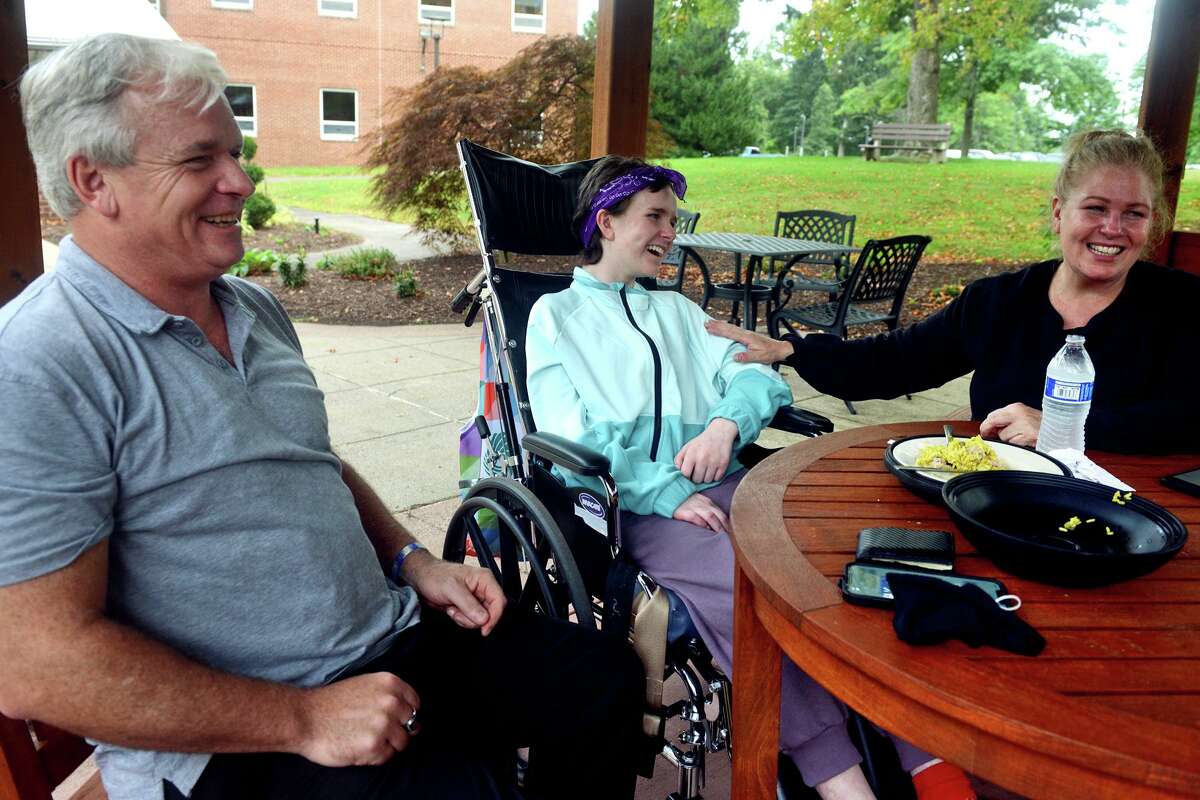 Eva Houlihan sits with her parents, Jerry Houlihan and Elizabeth Gower, during an interview at Gaylord Hospital/Specialty Healthcare, in Wallingford, Conn. Sept. 24, 2021. Eva is recovering from a car accident in Southbury last April that left her boyfriend dead.