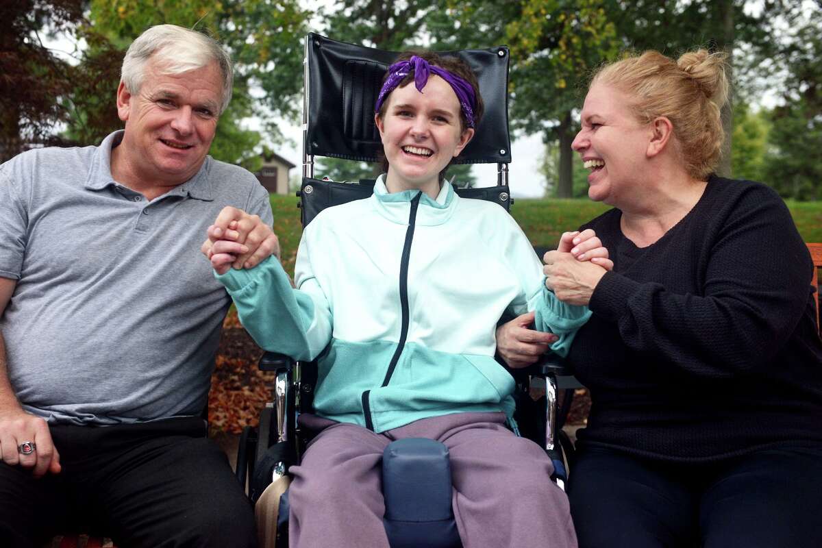 Eva Houlihan sits with her parents, Jerry Houlihan and Elizabeth Gower, at Gaylord Hospital/Specialty Healthcare, in Wallingford, Conn. Sept. 24, 2021. Eva is recovering from a car accident in Southbury last April that left her boyfriend dead.