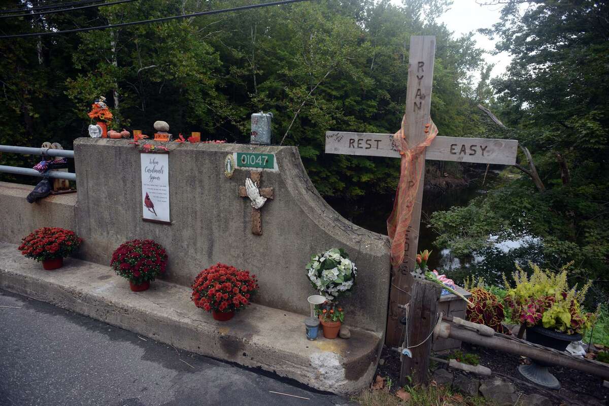 Memorials for Ryan Rutledge are set out on the Rt. 67 bridge over the Pomperaug River, in Southbury, Conn. Sept. 17, 2021. Rutledge, a Pomperaug High School student and athlete, was killed in an automobile accident at the bridge in April.