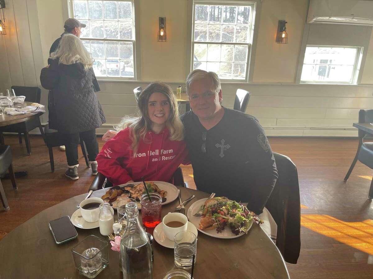 Eva Houlihan with her dad, Jerry Houlihan, at a recent brunch. Houlihan sometimes wears a wig as her hair is still growing back from the accident.