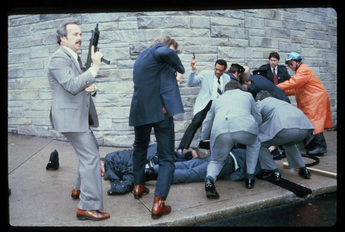 23374 06: Chaos surrounds shooting victims immediately after the assassination attempt on President Reagan, March 30, 1981, by John Hinkley Jr. outside the Hilton Hotel in Washington, DC. Injured in the shooting are Press Secretary James Brady and Agent Timothy McCarthy. (Photo by Dirck Halstead/Liaison)