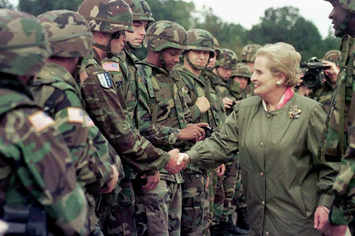U.S. Secretary of State Madeleine Albright shakes hands with soldiers during her visit to Air Base Eagle in Bosnia in 1998. Albright’s expertise on foreign policy was unparalleled.