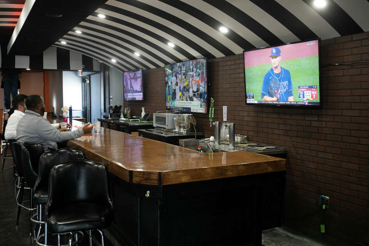 Patrons can enjoy a drink at the bar area while keeping up with all of the latest sports action.
