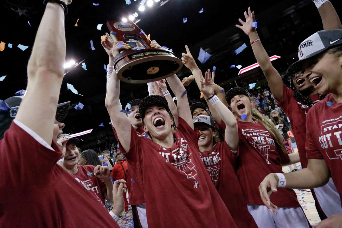 Stanford players celebrate with the regional trophy after they beat Texas 59-50 in a college basketball game in the Elite 8 round of the NCAA tournament, Sunday, March 27, 2022, in Spokane, Wash. Stanford won 59-50. (AP Photo/Young Kwak)