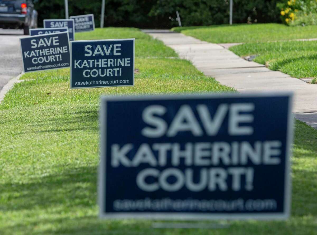 Save Katherine Court signs, made by neighbors who raised concerns with a proposed apartment complex, stand Tuesday, Sept. 14, 2021, along Katherine Court in Alamo Heights.