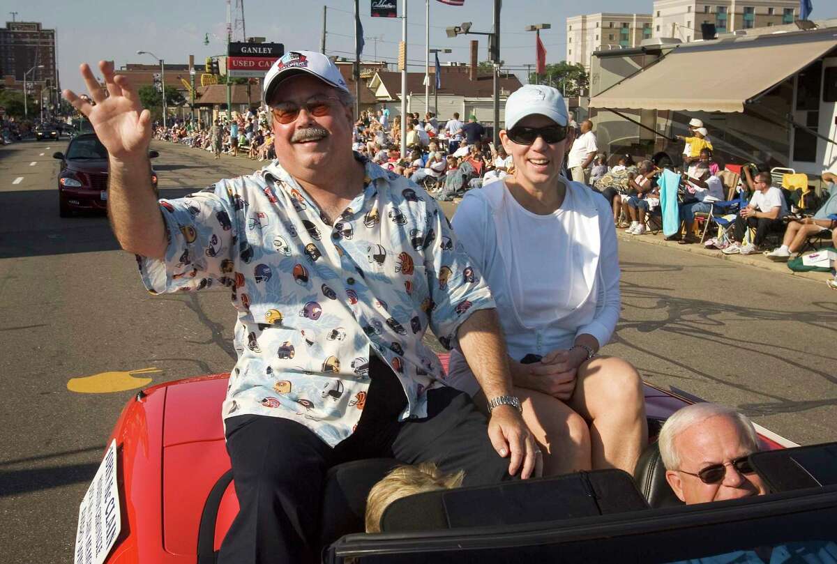 Longtime Houston Chronicle NFL writer John McClain is pictured with his wife Carol, during a parade in Canton, Ohio, before he was awarded the 2006 Dick McCann Memorial Award (now the Bill Nunn Memorial Award) from the Pro Football Hall of Fame. McClain retired from the Chronicle this week after 47 years with the newspaper.