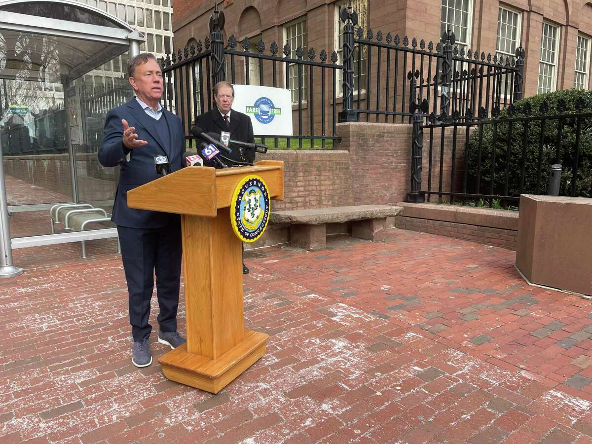 Gov. Ned Lamont speaks outside the Old State House on Main Street in Hartford alongside DOT Deputy Commissioner Mark Rolfe on Wednesday March 30, 2022.