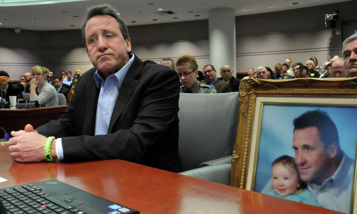 In this 2013 file photo, Sandy Hook victim father Neil Heslin of Shelton is pictured with his son Jesse Lewis.
