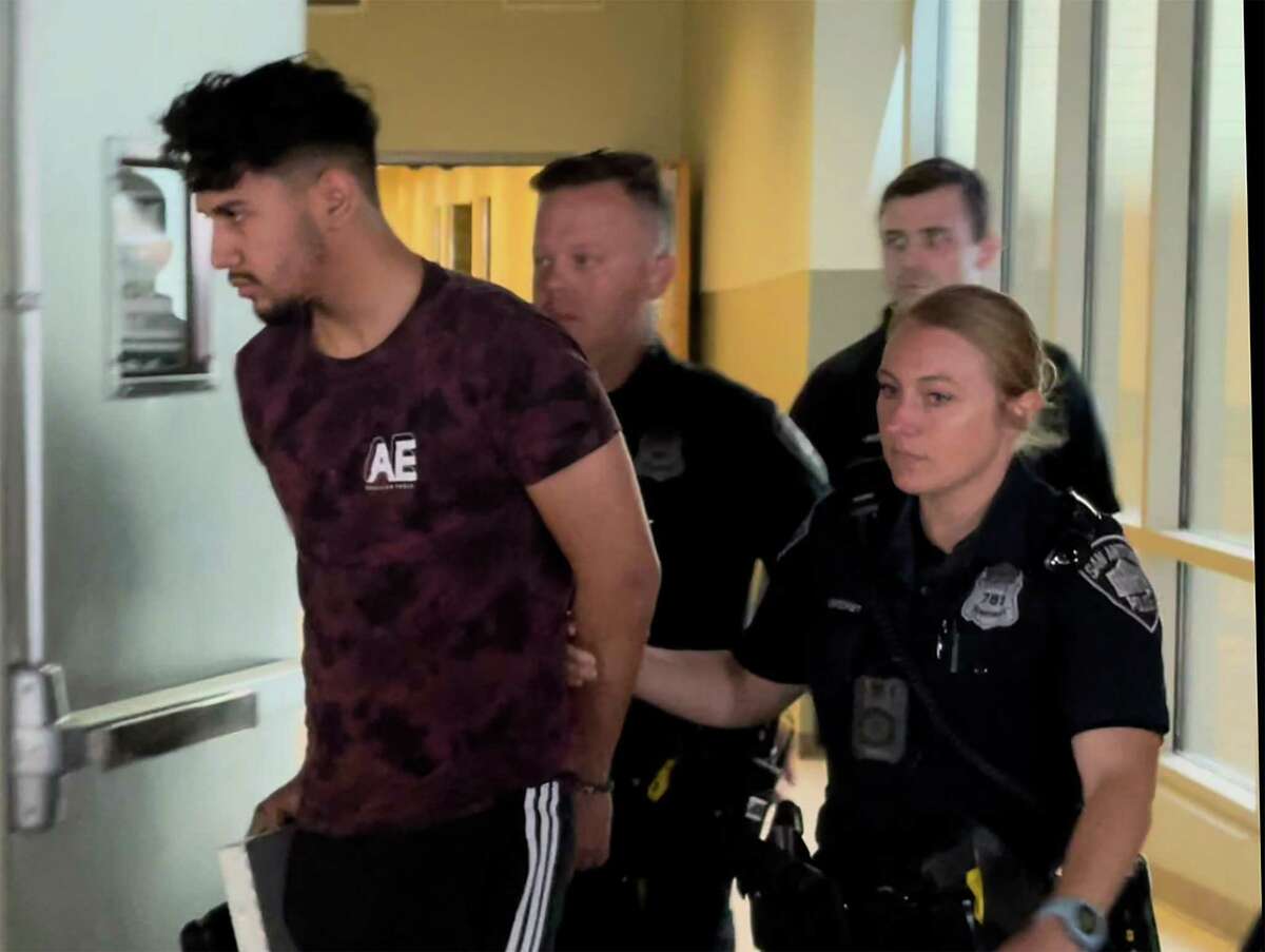 Kevin Luna, 18, is taken to a police vehicle on Wednesday, March 30, 2022, at the Public Safety Headquarters downtown. He is facing a capital murder charge in the death of Patrick Zavala, 27.