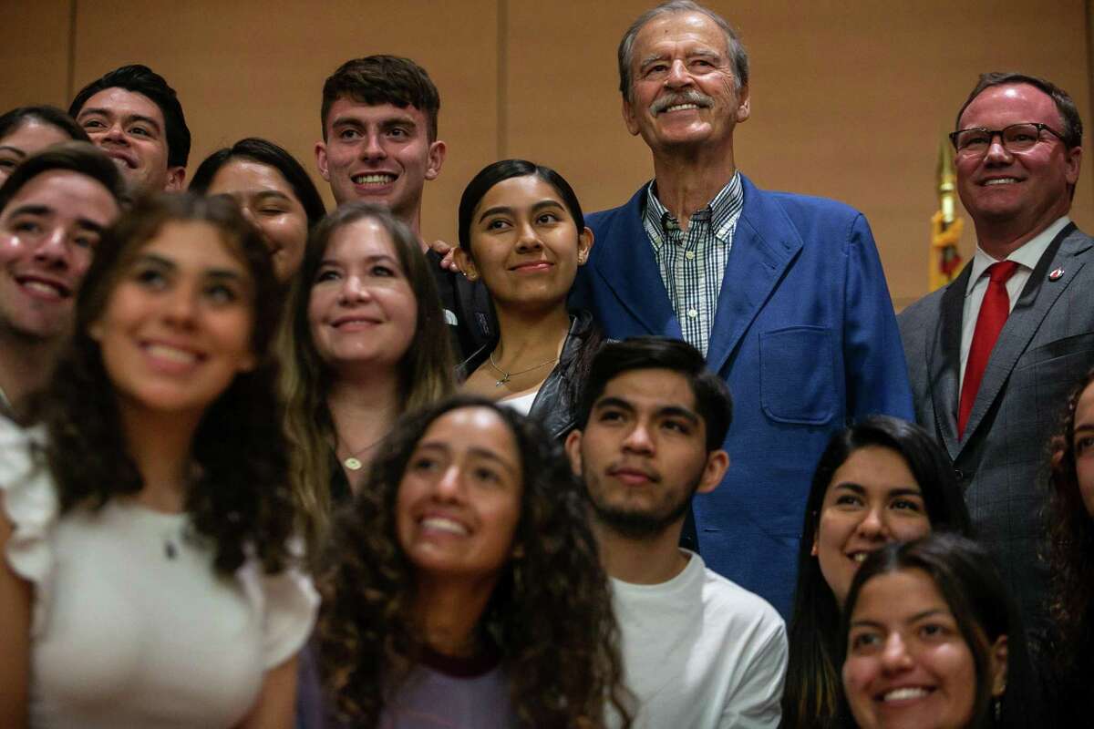Former Mexican President Vicente Fox, center, and UIW President Thomas M. Evans, right, join students after the first “Leaders of the Americas" lecture at the University of the Incarnate Word, where Fox praised immigrants’ contributions to the U.S.