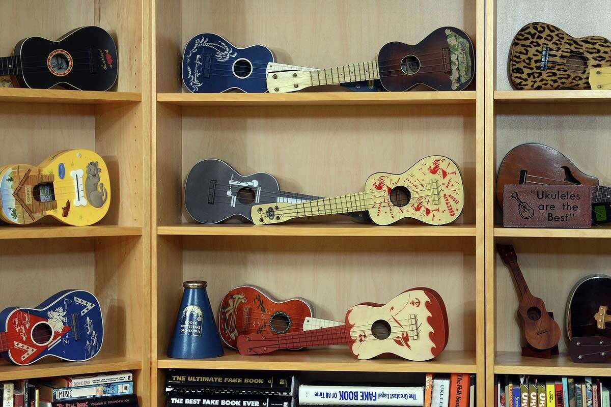 Jim Beloff has dozens of ukuleles from his collection on display in his home in Clinton.