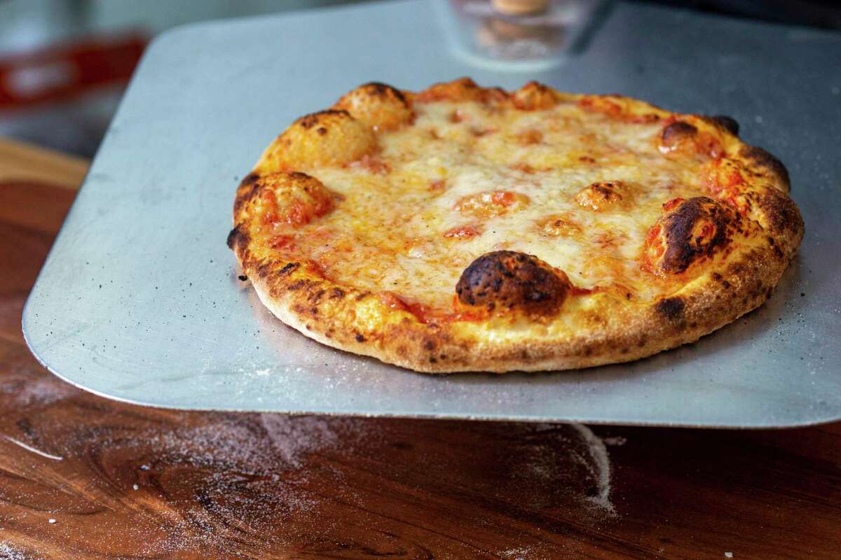 Pizza comes out of the oven with melted, animal-free mozzarella from New Culture.