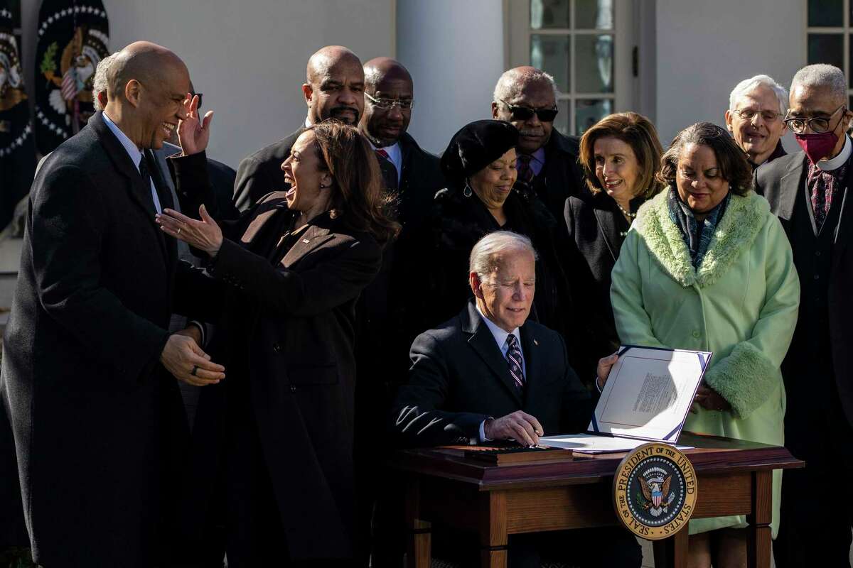 President Joe Biden signs the Emmett Till Anti-Lynching Act, making lynching a hate crime under federal law, during a ceremony in the Rose Garden of the White House on Tuesday.