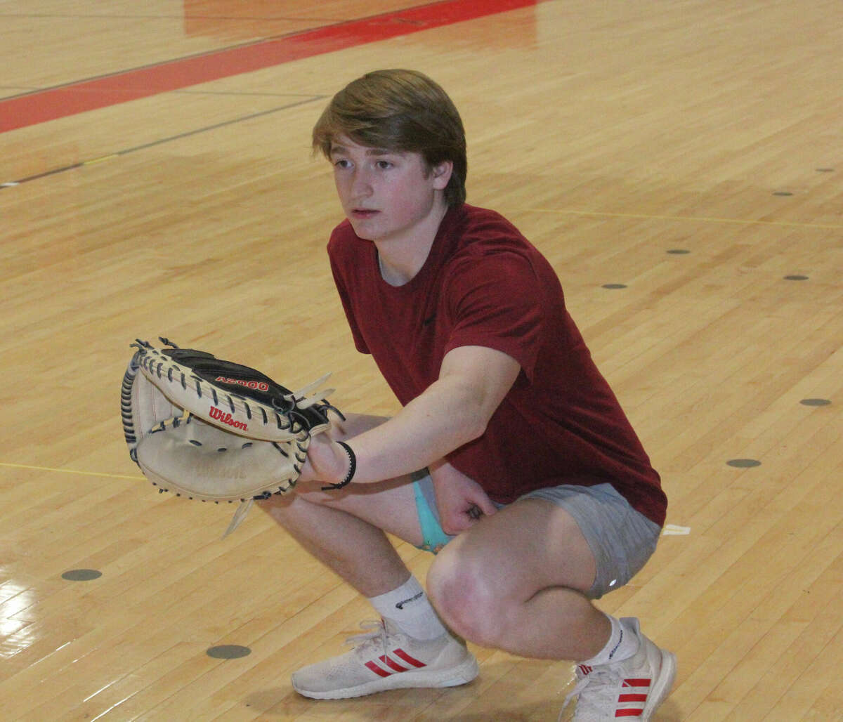 Big Rapids junior Wil Strickler works on his catching in the high school's auxiliary gym during a recent practice.
