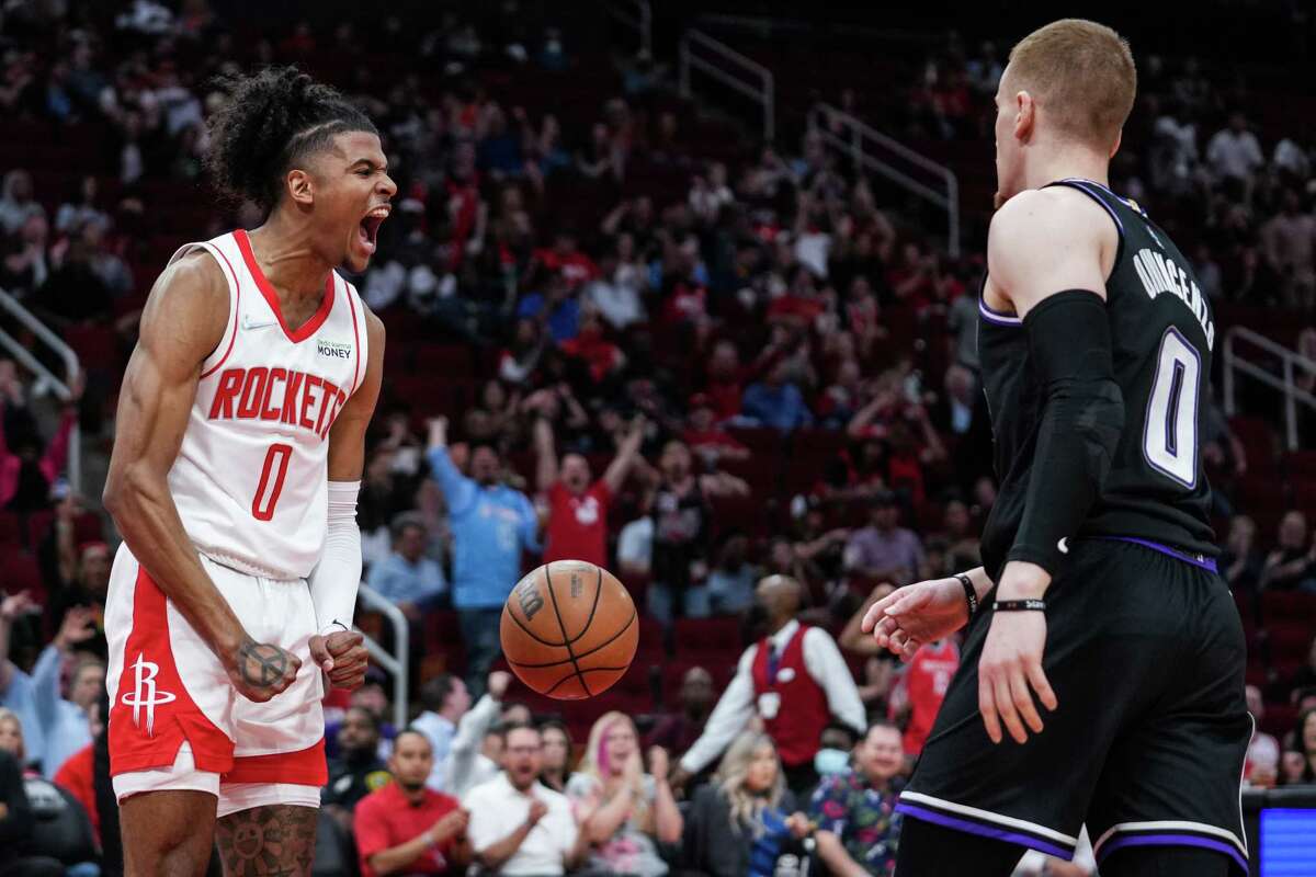 Houston Rockets guard Jalen Green reacts after scoring on a dunk against the Sacramento Kings during the first half of an NBA basketball game Wednesday, March 30, 2022, in Houston.
