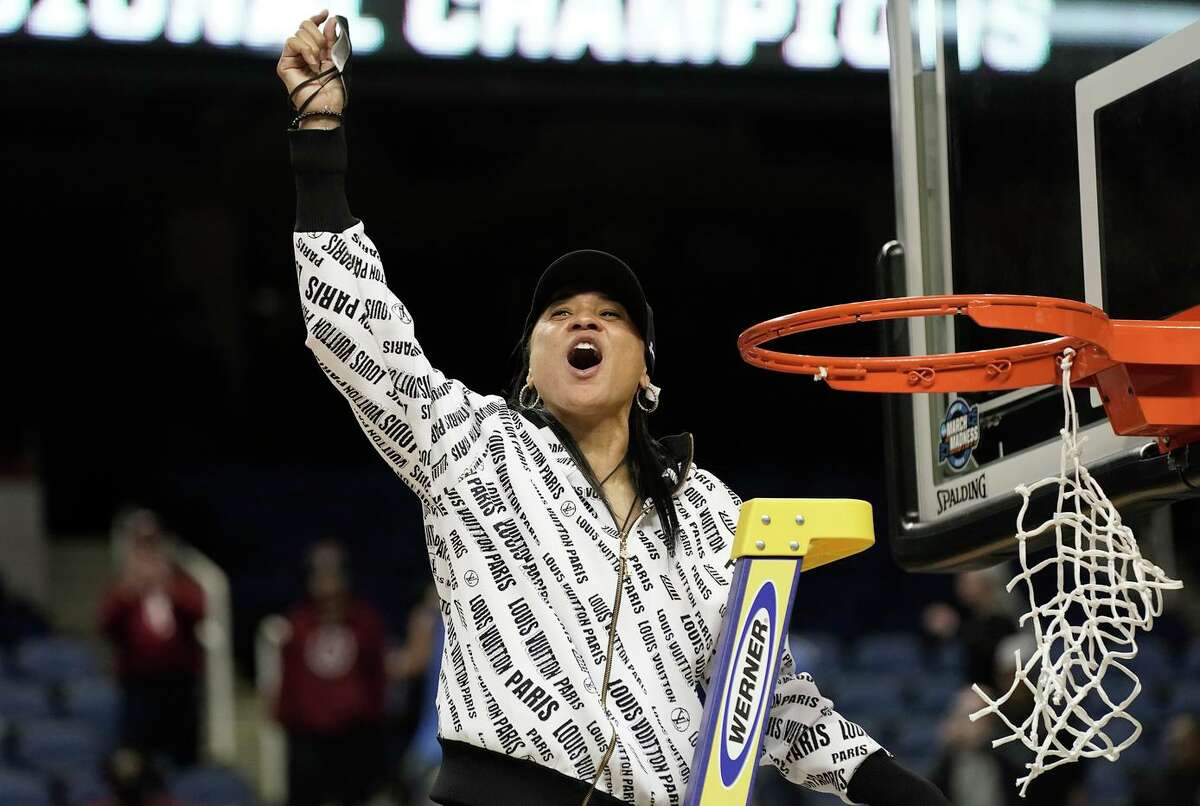 South Carolina head coach Dawn Staley reacts while cutting the net following a regional final victory over Creighton. Staley is the Naismith and U.S. Basketball Writers’ Coach of the Year.