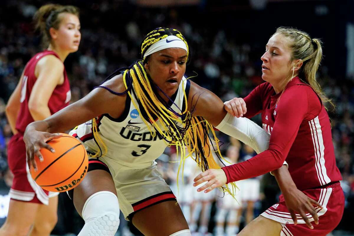 Connecticut forward Aaliyah Edwards (3) drives against Indiana guard Nicole Cardano-Hillary (4) during the second quarter of a college basketball game in the Sweet Sixteen round of the NCAA women's tournament, Saturday, March 26, 2022, in Bridgeport, Conn. (AP Photo/Frank Franklin II)