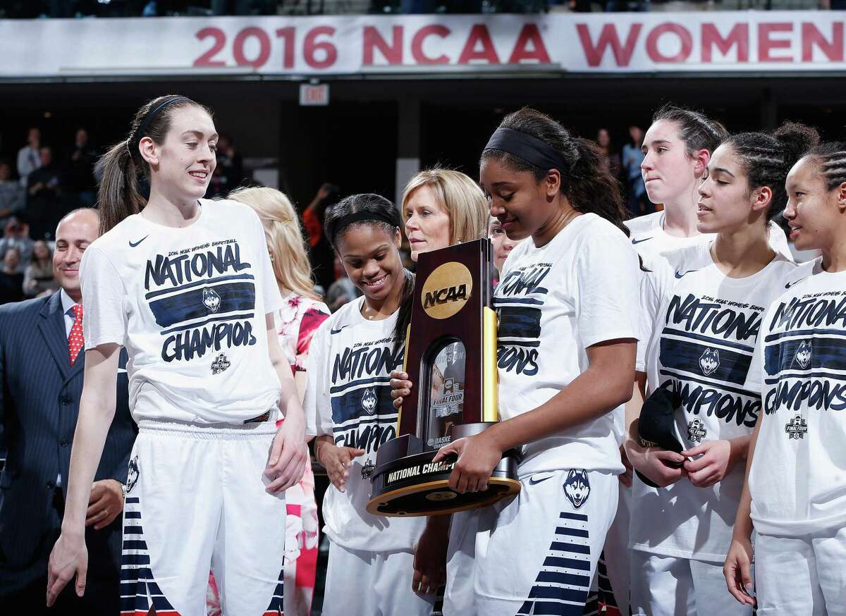 INDIANAPOLIS, IN - APRIL 05: Breanna Stewart #30, Moriah Jefferson #4, Morgan Tuck #3, Kia Nurse #11 and Saniya Chong #12 of the Connecticut Huskies celebrate with the trophy after their 82-51 victory over the Syracuse Orange to win the championship game of the 2016 NCAA Women's Final Four Basketball Championship at Bankers Life Fieldhouse on April 5, 2016 in Indianapolis, Indiana. Connecticut won 82-51. (Photo by Joe Robbins/Getty Images) ORG XMIT: 598514269