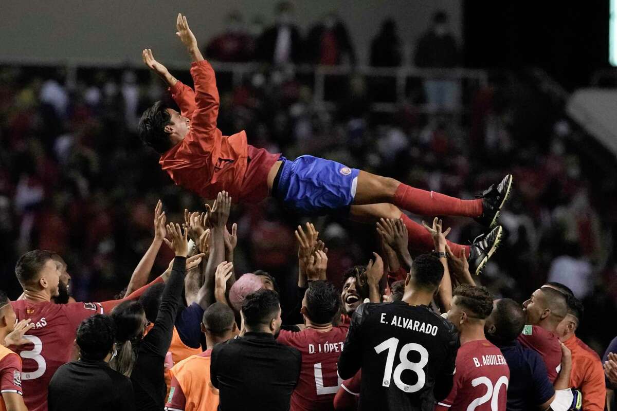 Teammates toss Costa Rica's Bryan Ruiz into the air after beating the United States 2-0 in a qualifying soccer match for the FIFA World Cup Qatar 2022 in San Jose, Costa Rica, Wednesday, March 30, 2022. Although the US lost the match the team qualified to the World Cup. (AP Photo/Moises Castillo)