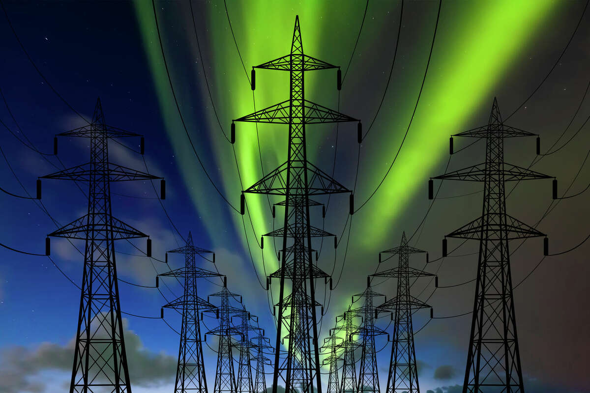 A file photo of some high voltage towers at the northern lights. 
