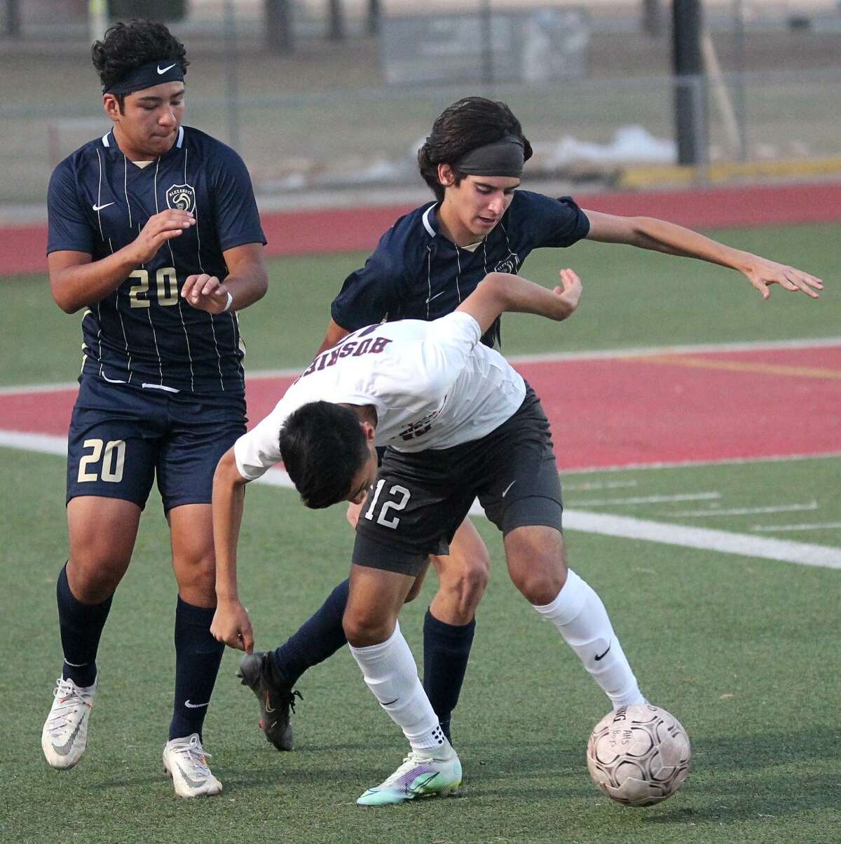 Alexander’s Santiago Chincilla and Jose Uvalle (20) fight for the ball in their own end during the first half of the Bulldogs’ 4-2 overtime win over La Joya Juarez Lincoln in the Area Round on Tuesday.
