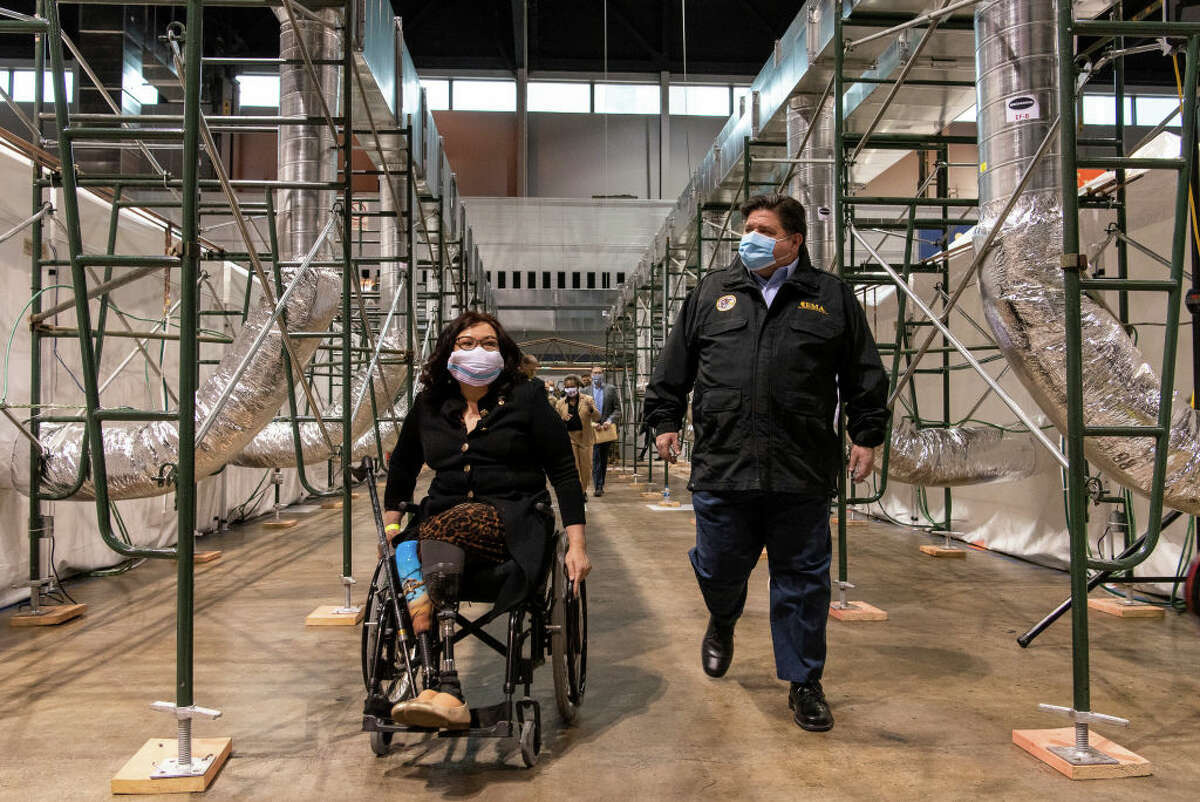 Sen. Tammy Duckworth and Illinois Gov. J.B. Pritzker tour the COVID-19 alternate care facility at the McCormick Place convention center in Chicago.