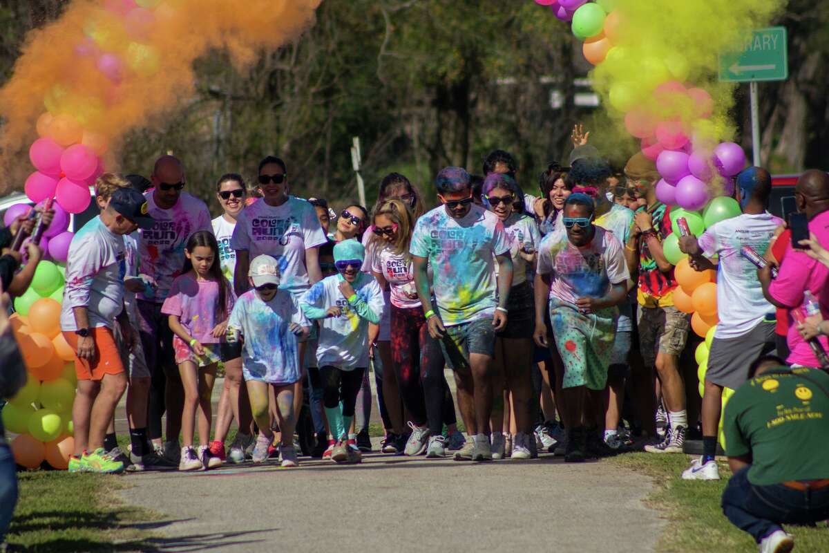 Participants prepare to begin Community Project Prom’s Color Run fundraiser for Northbrook and Spring Woods High School proms at the Emnora Bike Trail by Northbrook High School on Saturday, March 26.