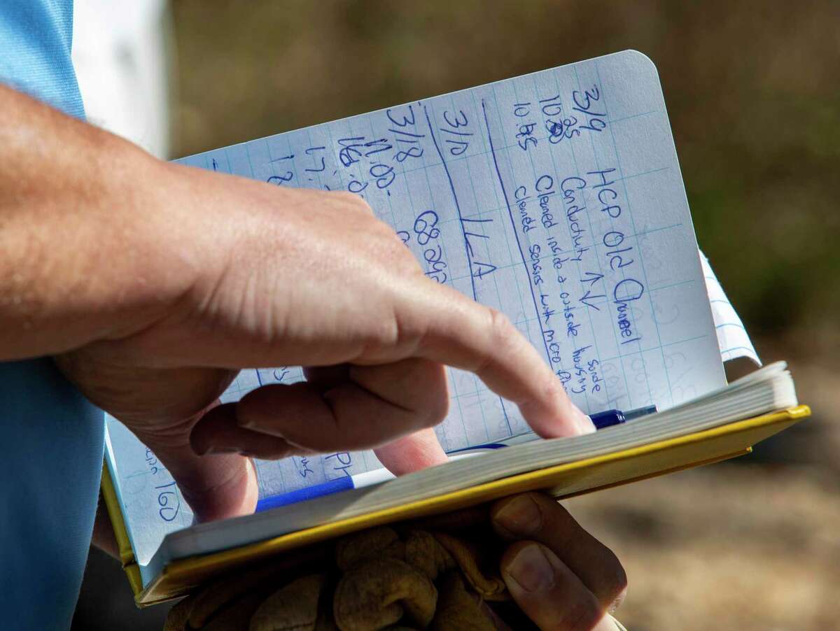 Charles Crawford, data collection supervisor at the Edwards Aquifer Authority, checks data on Wednesday, March 30, 2022, in a notebook of an EAA well at the authority’s Field Research Park in far north San Antonio.