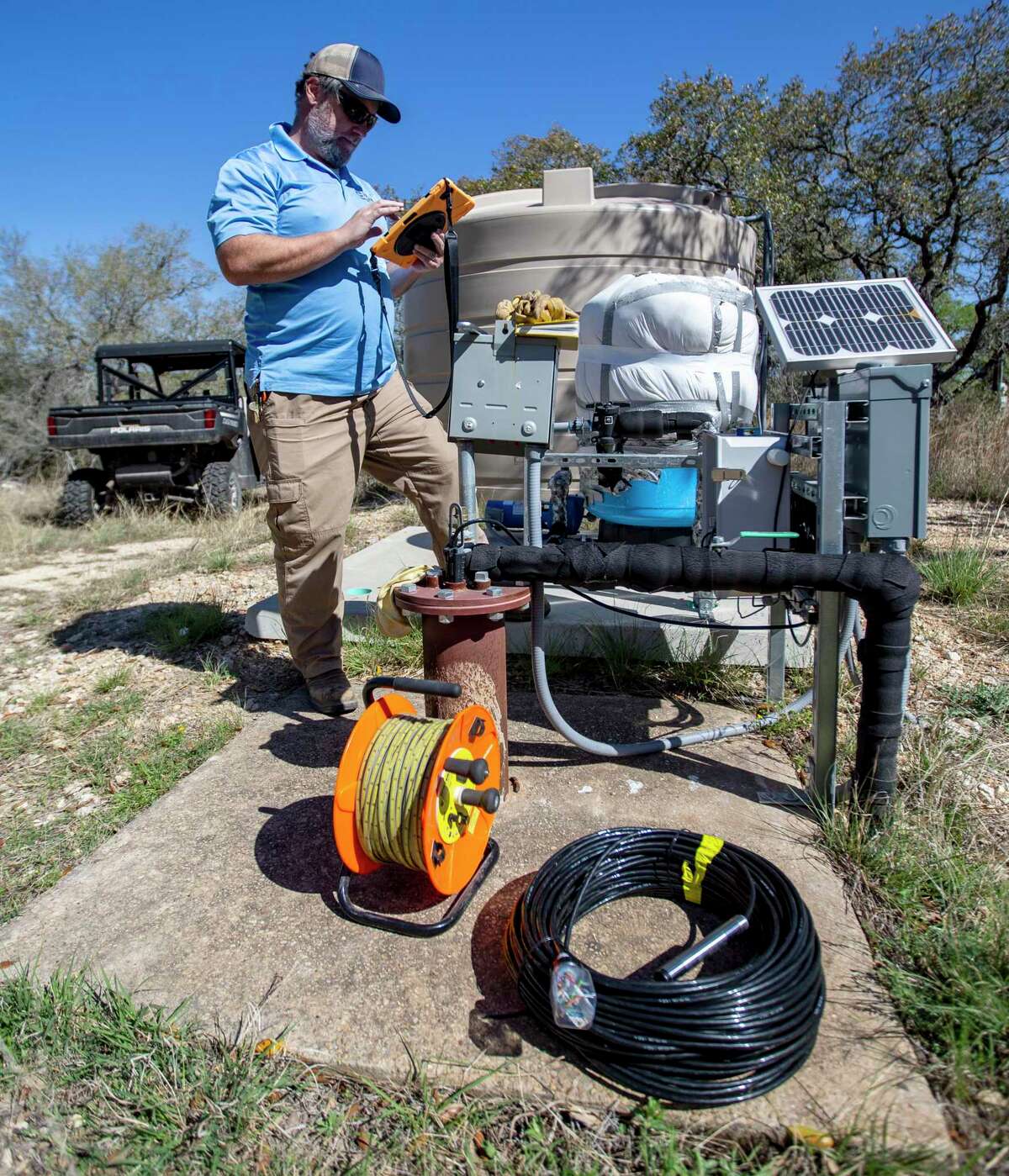 Charles Crawford, data collection supervisor at the Edwards Aquifer Authority, prepares on Wednesday, March 30, 2022, to measure the water level of well at the authority’s Field Research Park in far north San Antonio.