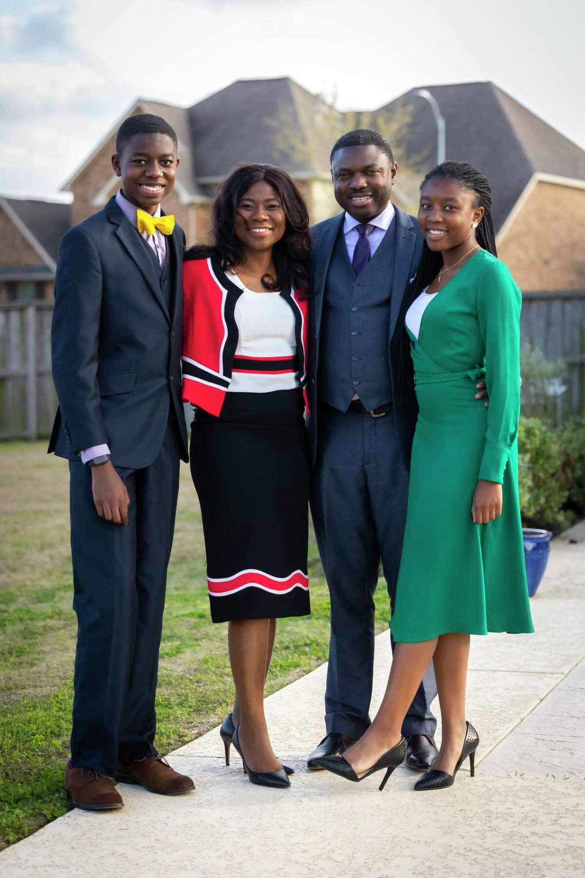 The Owoeye family in their Richmond home on Monday, March 28, 2022. Father Bola and mother Yemi, and daughter Kanyinsola, 15, and son Jola, 14.