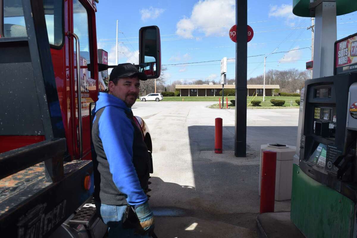 Kerry Tillitt, owner of Tillitt Collision Center in Quincy, fuels his tow truck. Tillitt paid $100 for 20 gallons of gas.