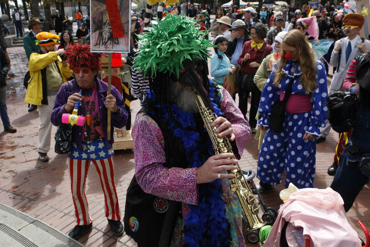 Geoff Walker, left, from San Francisco, weed man, middle, and Kelly Moore, right, from Marin meet at Justin Herman Plaza for the 35th annual Saint Stupid's Day Parade in San Francisco on Monday, April 1, 2013.