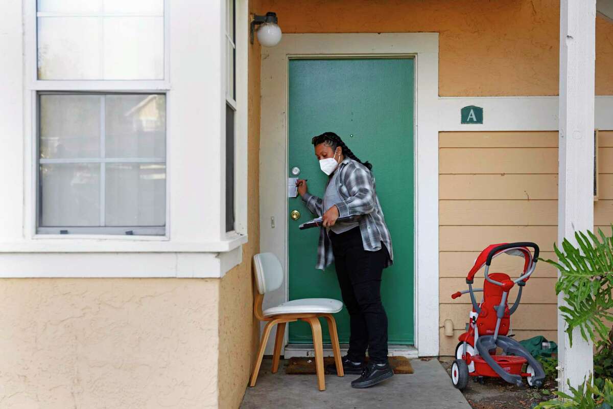 Housing organizer Cristal Little knocks on doors Tuesday in Vallejo, two days ahead of California’s deadline to apply for rent relief. Eviction protections are extended for those who have applied.