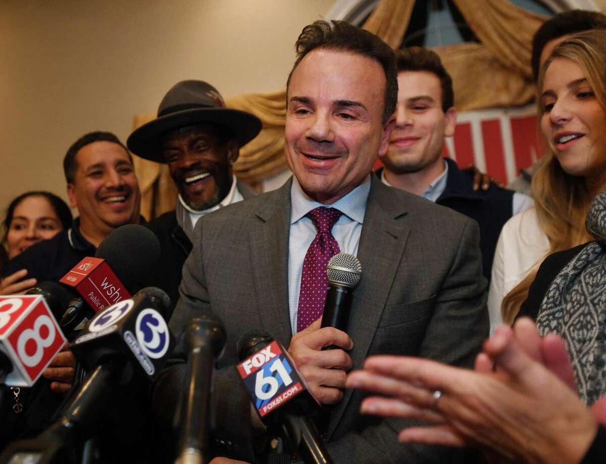 Surrounded by family and supporters, Bridgeport Mayor Joe Ganim smiles as he delivers his re-election victory speech at Testo's Restaurant in Bridgeport, Conn. on Tuesday, November 5, 2019.