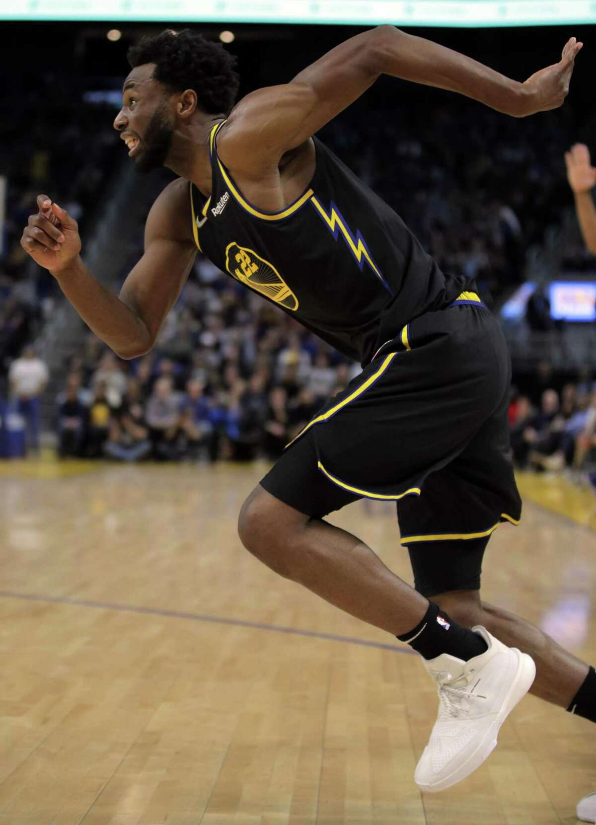 Andrew Wiggins (22) runs in to chase down a rebound as the Golden State Warriors played the Phoenix Suns at Chase Center in San Francisco, Calif., on Wednesday, March 30, 2022.