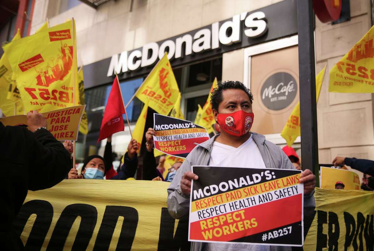 Jose Ramirez participates in a lunchtime protest of a San Francisco McDonald’s on Tuesday, Feb. 15, 2022. Ramirez says he was fired by the business after he took two weeks off to recuperate from COVID and requested sick pay in January. Ramirez relied on his income to help pay the bills at the San Francisco home he shares with his partner, their three children, Ramirez’s father and four other roommates.
