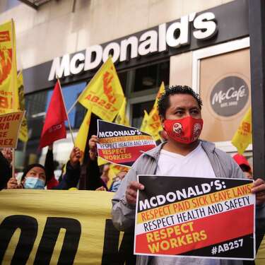 Jose Ramirez poses with other protesters as they hold a lunchtime rally in front of McDonald’s on Tuesday, Feb. 15, 2022, in San Francisco , Calif. McDonald’s cooks and cashiers will hold a lunchtime rally to protest the unlawful firing of a co-worker who requested COVID-19 sick pay after testing positive for the virus. The fired worker, Jose Ramirez, regularly raised concerns about health and safety at his McDonald’s store before eventually contracting COVID-19.
