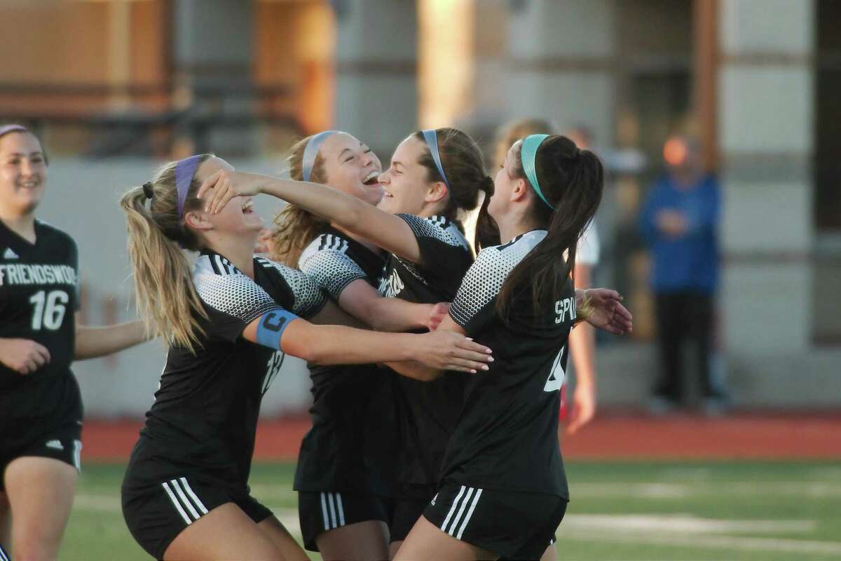 Friendswood's Olivia Schmidt (7) is swarmed by teammates after scoring a goal against Manvel Thursday, Mar. 31, 2022 at Alvin High School.