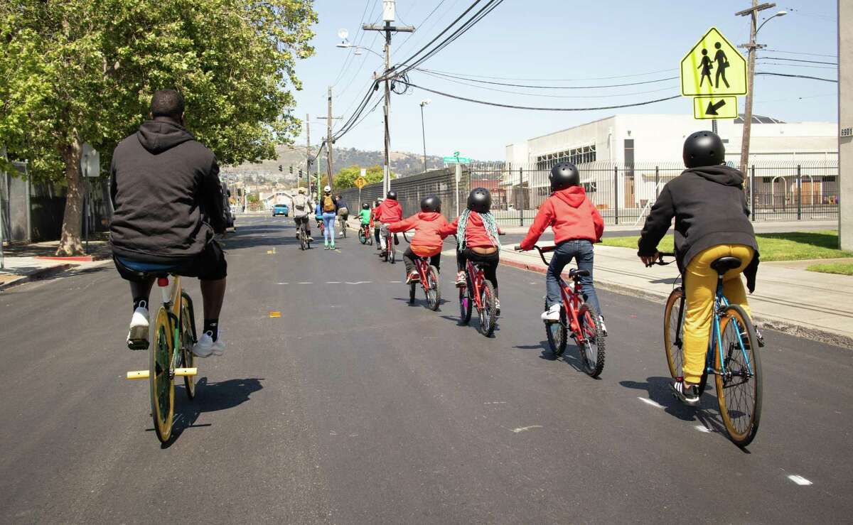 Bike mentor Fred Rogers rides with students on a community bike ride through East Oakland.