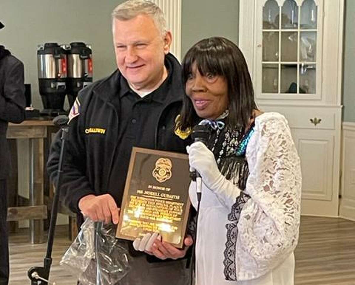 Torrington resident Norell Gaudaitis celebrated her 94th birthday with a party at Crystal Peak March 27. She was honored by family and friends, and by the Torrington Police Department, of which she is a devoted supporter. Chief William Baldwin, left, presents Gaudaitis with a commemorative plaque.