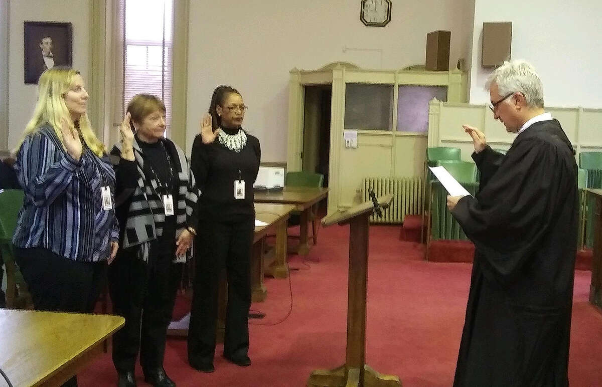 Judge Jeffery Tobin swears in court-appointed special advocates Erica Atterberry (from left), Marilyn Kimmons and Regina Williams on Thursday at the courthouse.