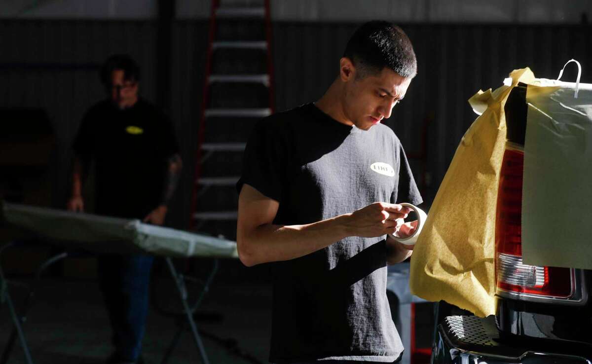 Eduardo Barrera works on preparing a truck to be painted at Line-X, Thursday, March 31, 2022, in Conroe. The business along FM 1484 specializes in protective coatings and spray-on bedliners for vehicles in addition to custom jobs.