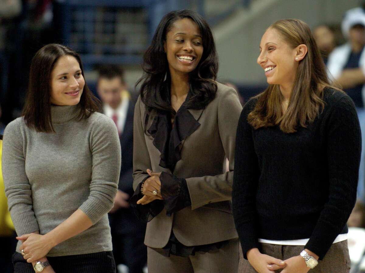 Former University of Connecticut women's basketball players Sue Bird, left, Swin Cash, center, and Diana Taurasi share a light moment during the Huskies of Honor induction ceremony at Gampel Pavillion in Storrs, Conn., Thursday, Dec. 21, 2006. Ten First Team All-Americans and Hall of Fame head coach Geno Auriemma were honored as the inaugural class. (AP Photo/Jessica Hill)