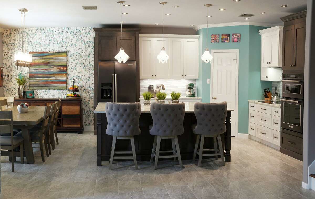The builder-grade Helotes kitchen of Penny and Don Wuebben was upgraded to a two-tone room with higher-end appliances, fixtures and surfaces.
