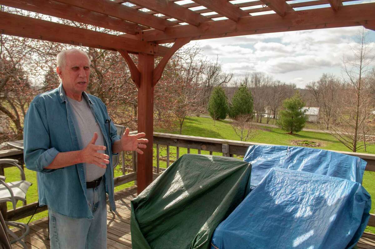 Pike County resident Jeff Ruzicka stands on his back patio, explaining where a proposed cannabis craft facility could be built if the county board approves a zone change. He said it would be 200 feet from his house.