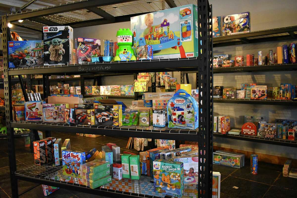 Toy Town's grand opening in downtown Reed City featured a variety of children's toys, a coloring and painting station, a play mat complete with a slide, and a special visitor in Santa who talked all things toys with the kids in attendance.