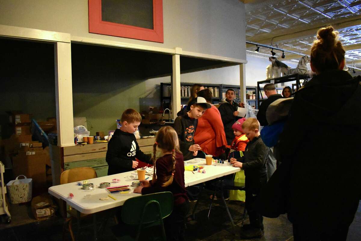 Toy Town's grand opening in downtown Reed City featured a variety of children's toys, a coloring and painting station, a play mat complete with a slide, and a special visitor in Santa who talked all things toys with the kids in attendance.