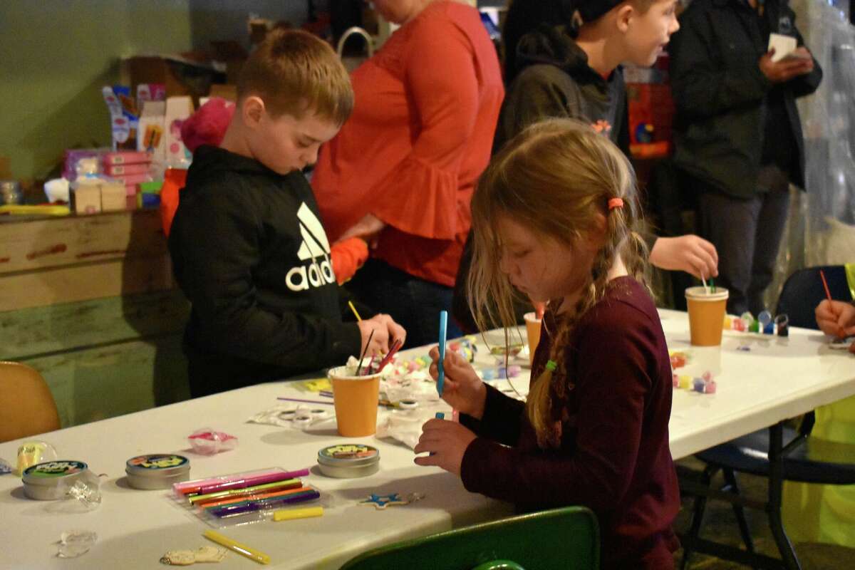 Toy Town's grand opening in downtown Reed City featured a variety of children's toys, a coloring and painting station, a play mat complete with a slide, and a special visitor in Santa who talked all things toys with the kids in attendance.