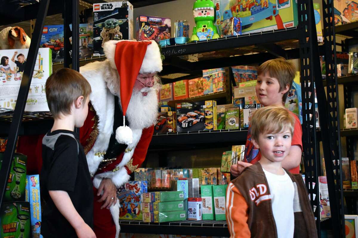 Toy Town's grand opening in downtown Reed City featured a variety of children's toys, a coloring and painting station, a play mat complete with a slide, and a special visitor in Santa who talked all things toys with the kids in attendance.