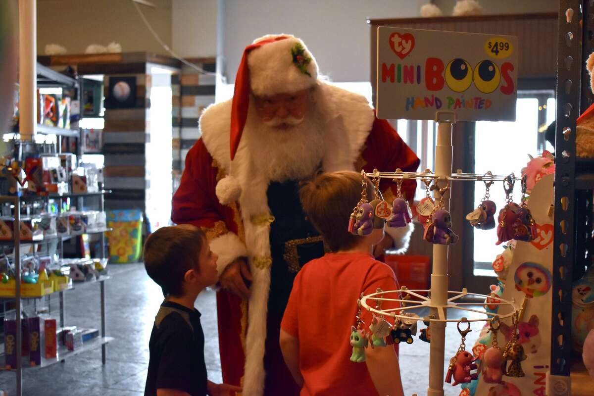Toy Town's grand opening in downtown Reed City featured a variety of children's toys, a coloring and painting station, a play mat complete with a slide, and a special visitor in Santa who talked all things toys with the kids in attendance.